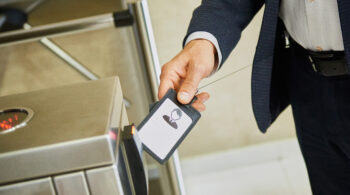 A man uses an electronic pass to pass through the turnstile. Ensuring the security of the company. Electronic document